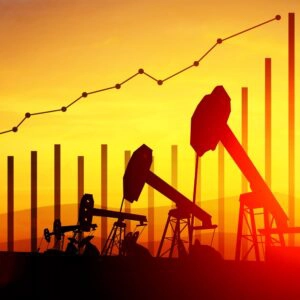 Oil and gas data chart with oil wells at sunset in background